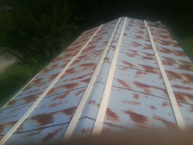 Rusted metal roof panels with new wood purlins before replacement — Storm Damage Roof Repair in Talbotton by Roofing Brothers